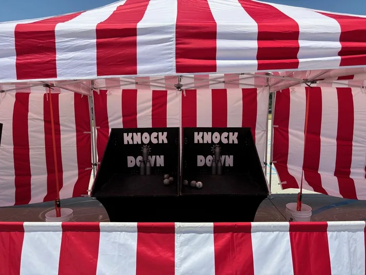 Full carnival pack bundle — staffed carnival booth under a red and white striped tent