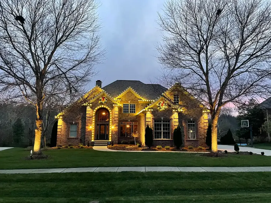 Warm-white C9 LED Christmas light installation on a home at dusk — serving Coquitlam, BC