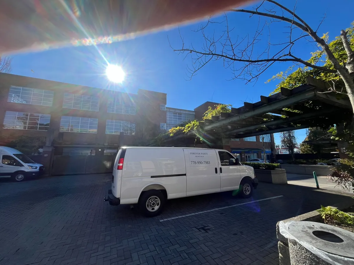 One of our white cargo vans with the Forever Party Rentals name and phone number on the side
