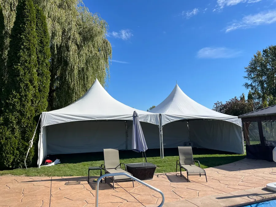 Backyard party rental packages — two high-peak tents with sidewalls beside a backyard pool