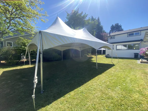 20x40 marquee tent rental set up on a backyard lawn