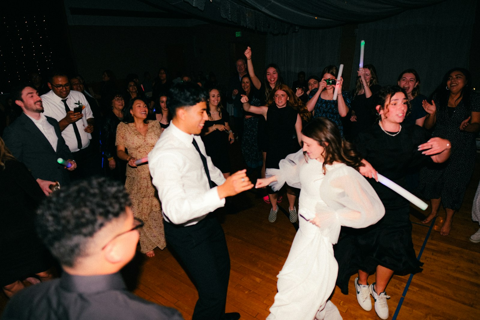 Two people dancing together at a wedding reception in formal attire