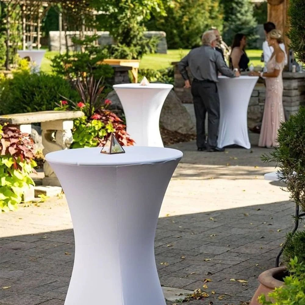 Cocktail-hour highboy tables set up on an outdoor patio with guests in conversation in the background