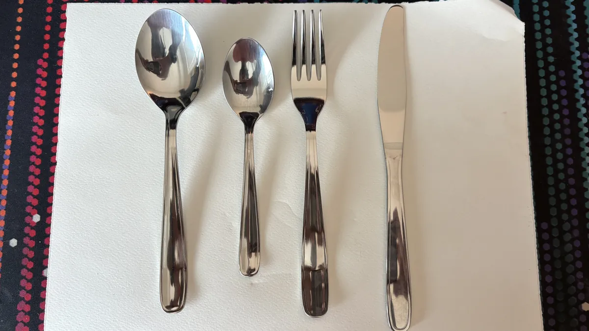 Stainless cutlery rental set — dinner spoon, teaspoon, dinner fork and dinner knife from Forever Party Rentals