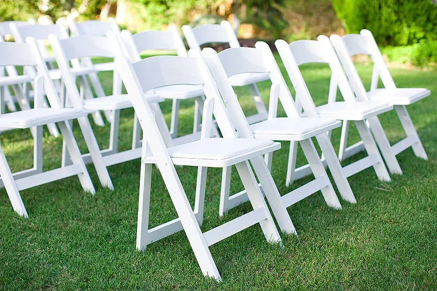 White resin garden chair rentals for outdoor events — Forever Party Rentals